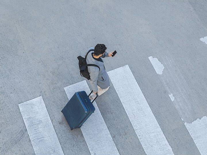 Man using Last Mile Guidance on his smartphone while crossing the street.